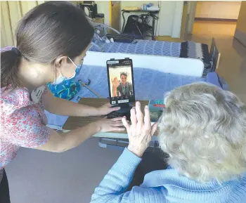  ??  ?? Recreation Therapist Jenna setting up a video call.