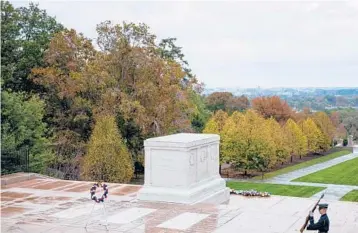  ?? DAMON WINTER/THE NEW YORK TIMES 2019 ?? A member of The Old Guard keeps watch at the Tomb of the Unknown Soldier at Arlington National Cemetery in Virginia. Since 1948, a 24-hour military guard has kept the public from the sarcophagu­s.