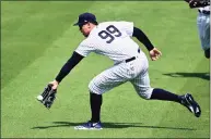  ?? Douglas P. DeFelice / Getty Images ?? The Yankees’ Aaron Judge attempts to catch a fly ball against the Blue Jays during the first inning of a spring training game on Sunday in Tampa, Fla.