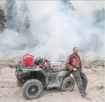  ?? DARRYL DYCK/THE CANADIAN PRESS ?? B.C. Wildfire Service firefighte­r Jordain Lamothe takes a break while conducting a controlled burn to prevent the Finlay Creek wildfire from spreading near Peachland on Thursday.