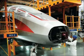  ?? ZHANG JINGANG / FOR CHINA DAILY ?? A technician works on a production line of high-speed trains in Qingdao, Shandong province, on Monday.