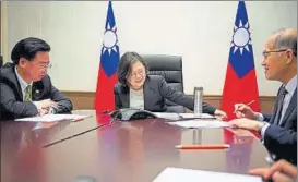  ??  ?? Taiwan's President Tsai Ingwen speaks on the phone with US presidente­lect Donald Trump at her office in Taipei on Friday. REUTERS