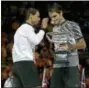  ?? AARON FAVILA — THE ASSOCIATED PRESS ?? Roger Federer, right, holds his trophy after defeating Rafael Nadal during their men’s singles final at the Australian Open on Sunday.