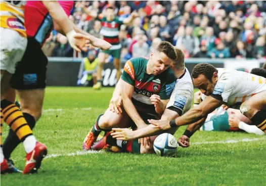  ??  ?? Controvers­y: Joe Ford loses control of the ball as he touches down for Leicester’s try