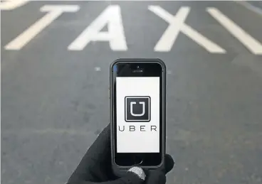  ?? /Reuters ?? Push and ride: Uber still uses its service with profession­al licensed drivers in France that is not affected by the ruling.