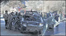  ?? AP ?? Afghan security personnel inspect the site of a bomb attack in Kabul on Saturday.