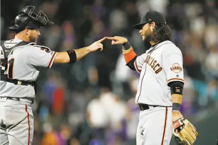  ?? David Zalubowski / Associated Press ?? The Giants’ Stephen Vogt and Brandon Crawford each hit a solo homer to account for both of the Giants’ runs in the nightcap.