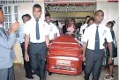  ?? PHOTO BY GARETH DAVIS SR ?? Pall-bearers carrying the remains of student pilot Ramone Forbes, who died during a plane crash recently.