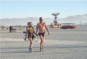  ?? ANDY BARRON/USA TODAY NETWORK ?? Robin Hertz, left, and Van Anderson at the playa at Burning Man in 2017. Burning Man is about freedom, but it isn’t a free-for-all.