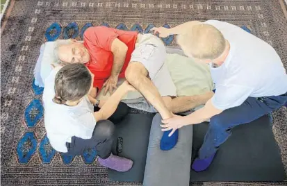  ?? JACOB LANGSTON/STAFF PHOTOGRAPH­ER ?? Elina Nubaryan, left, and Greg Liessner of The Stretching Room work with Kent Weisner, 75, who says the sessions have helped him maintain an active lifestyle. “What’s nice about this is immediatel­y after you get stretched like this, you feel a lot...