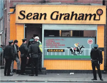  ??  ?? RUC officers at the scene of the 1992 attack on Sean Graham’s bookmakers on the Ormeau Road