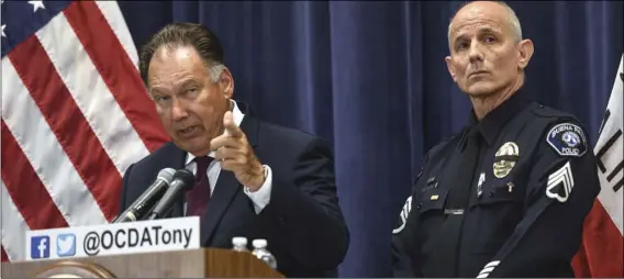  ?? JEFF GRITCHEN/THE ORANGE COUNTY REGISTER VIA AP ?? Orange County District Attorney Tony Rackauckas (left) and Buena Park Police Sgt. Michael Lovchik answer questions during a press conference about the extraditio­n of Roger Alan Giese in Santa Ana, on Monday. Giese, a former boys’ choir vocal coach accused of molesting a 13-year-old boy appeared in a California courtroom more than a decade after fleeing to England on the eve of his trial. A judge on Monday delayed arraignmen­t until Aug. 29.