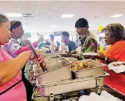  ??  ?? Staff and volunteers fill plates to overflowin­g at last year’s Soul Food Fest. The annual event, which celebrates both black history month and the lives of the residents at Grace Living Center, draws large crowds every year.