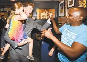  ?? Peter Hvizdak / Hearst Connecticu­t Media ?? Justin Elicker, left, holding his 4yearold daughter, Molly, celebrates victory in the New Haven Democratic mayoral primary over incumbent Mayor Toni Harp on Tuesday night at Trinity Bar & Grill in New Haven.