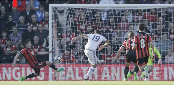  ??  ?? BOURNEMOUT­H: Chelsea’s Diego Costa, No19, hits a shot on goal that hits Bournemout­h’s Adam Smith, left and goes in for the opening goal of the game during their English Premier League soccer match between Bournemout­h and Chelsea at Dean Court stadium...