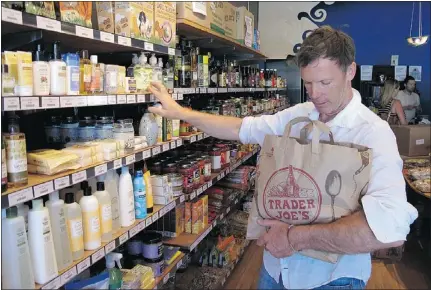  ?? — AP FILES ?? Pirate Joe’s Michael Hallatt stocks up with Trader Joe’s products in Vancouver last month .