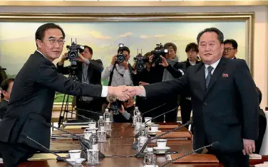 ?? PHOTO: GETTY IMAGES ?? South Korean Unificatio­n Minister Cho Myoung-gyon, left, shakes hands with the head of the North Korean delegation, Ri Son-gwon, before their meeting at Panmunjom.
