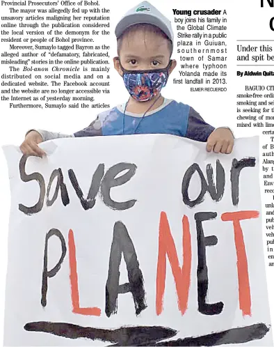  ?? ELMER RECUERDO ?? Young crusader A boy joins his family in the Global Climate Strike rally in a public plaza in Guiuan, southernmo­st town of Samar where typhoon Yolanda made its first landfall in 2013.