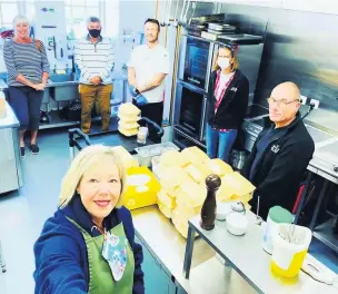  ??  ?? Staff at Llanelly House prepare to deliver meals to two local care homes.