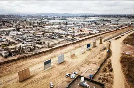  ?? JOSH HANER / THE NEW YORK TIMES 2017 ?? Eight border wall prototypes stand last year in front of the existing wall on the U.S.Mexico border in Otay Mesa, Calif. The Trump administra­tion wants new authority to acquire land in the area to more quickly build barriers.