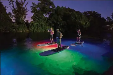  ?? CONTRIBUTE­D BY ANDY HEATWOLE ?? Glow Paddle Austin offers nighttime tours aboard paddleboar­ds illuminate­d with colorful lights.