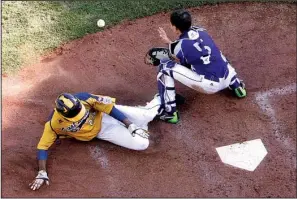  ?? AP/GENE J. PUSKAR ?? Chicago’s Trey Hondras (left) scores ahead of the throw to South Korea catcher Sang Hoon Han (5) in the sixth inning of Chicago’s 8-4 loss to Seoul, South Korea, in the championsh­ip game of the Little League World Series on Sunday.