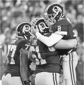  ?? GEOFF BURKE, USA TODAY SPORTS ?? Redskins quarterbac­k Kirk Cousins, right, celebrates after throwing a touchdown pass against the Packers on Sunday.