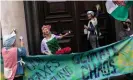  ?? Images ?? Extinction Rebellion activists scrubbing the doors of HMRC. Photograph: Dan Kitwood/Getty