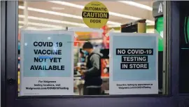  ?? PHOTO BY ROBYN BECK — AGENCE FRANCE PRESSE VIA GETTY IMAGES ?? A sign on the entrance to a pharmacy reads “Covid-19 Vaccine Not Yet Available” last week in Burbank. Once vaccines do arrive, getting them to the people who need them most will be one of the challenges facing health care providers and officials.