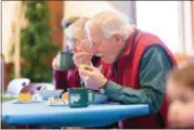  ?? CARRIE GARLAND — THE NEWS-HERALD ?? Winter Hike participan­ts warmed up with a hot meal at Penitentia­ry Glen Nature Center Feb. 10.