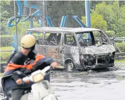  ?? AP ?? A burned car sits outside the office of the property developer MCT Berhad in Subang, Malaysia yesterday.