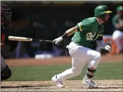  ?? BEN MARGOT – THE ASSOCIATED PRESS ?? The A’s Robbie Grossman hits a run-scoring single in the third inning of Saturdayh’s game against Houston.