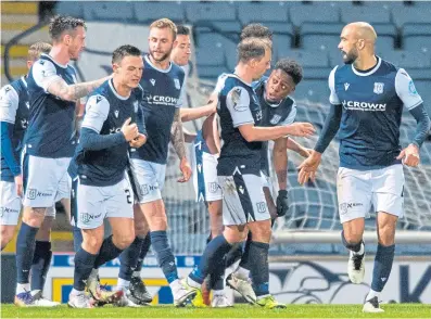  ??  ?? Dundee celebrate making it three against the Jambos last night