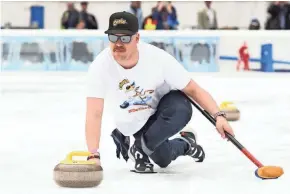  ?? NOAM GALAI/GETTY IMAGES ?? Matt Hamilton of the U.S. men's curling team joined Cheetos recently to demonstrat­e to fans how to curl at an event at the Bank of America Winter Village in New York.