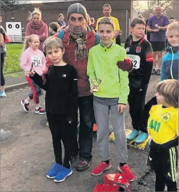  ??  ?? Alfie and George Bower received their trophies from Brian Vigrass before Saturday’s run.