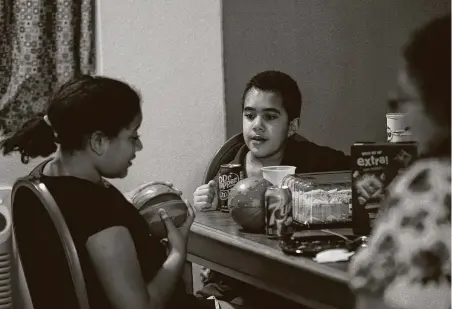  ??  ?? Na’Kahi Lawrence, 6, and his sister La’Keisha, 11, play after eating lunch in their motel room. Their mother, Jessica Lawrence, misses having the kids in school. “It’s impossible to live in a motel with kids,” she said.