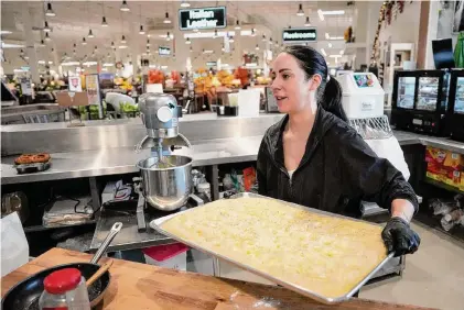  ?? Photos by Melissa Phillip/Staff photograph­er ?? Sophie Galindo prepares focaccia bread on Nov. 16 at Galindo’s Bakery + Deli inside American Furniture Warehouse in Conroe.