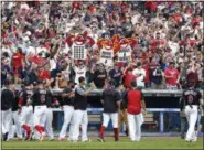  ?? RON SCHWANE — THE ASSOCIATED PRESS ?? Cleveland Indians fans celebrate a 5- 3victory over the Detroit Tigers in a baseball game Wednesday in Cleveland. The Indians set the American League record with 21 consecutiv­e wins.