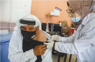  ?? (Raneen Sawafta/Reuters) ?? A PALESTINIA­N man receives a Sinopharm vaccinatio­n against the coronaviru­s in Tubas, near Nablus, in April.