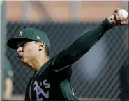  ?? DARRON CUMMINGS — THE ASSOCIATED PRESS ?? Oakland Athletics’ Jesus Luzardo throws during spring training baseball practice in Mesa, Ariz.