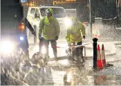  ??  ?? The Army has been sent in to flooded areas including Bentley, South Yorks, where they are helping to sandbag properties, above. Meanwhile, police are trying to help motorists navigate the waterlogge­d streets of the village, left