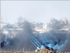  ?? ARIEL SCHALIT — THE ASSOCIATED PRESS ?? Israeli soldiers fire tear gas at Palestinia­n protesters during Friday’s confrontat­ion.