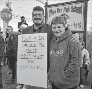  ?? NIKKI SULLIVAN/CAPE BRETON POST ?? Brett Corbett, 14, stands with his friend, Brandon Jolie, who helped organize an anti-bullying rally in Glace Bay earlier this week. Corbett, who has cerebral palsy, was used as a human bridge by fellow Glace Bay High School students and a video of the incident went viral. Jolie said he considers Corbett a brother and hopes students will learn this behaviour isn’t acceptable.