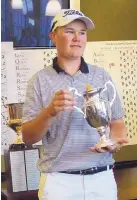  ?? ADOLPHE PIERRE-LOUIS/JOURNAL ?? Patrick McCarthy holds his trophy after winning the city men’s golf tournament. His 20-foot birdie on 18 settled it.