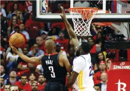  ?? (Reuters) ?? HOUSTON ROCKETS guard Chris Paul drives to the basket against Golden State Warriors defender Draymond Green for two of his 16 points in the Rockets’ 127-105 home victory over the Warriors in Wednesday’s Game 2 of the Western Conference finals.