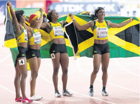  ?? GLADSTONE TAYLOR/MULTIMEDIA PHOTO EDITOR ?? Jamaicans (from left) Natalliah Whyte, Shelly-Ann Fraser-Pryce, Shericka Jackson and Jonielle Smith celebrate gold in the women’s 4x100m relay final at the 2019 IAAF World Athletic Championsh­ips, held at the Khalifa Internatio­nal Stadium in Doha, Qatar, earlier this year.