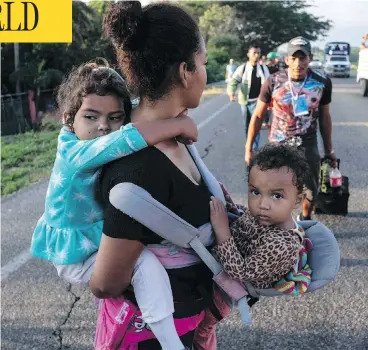  ?? GUILLERMO ARIAS / AFP / GETTY IMAGES ?? Migrants heading in a caravan to the U.S., walk along the road from La Ventosa to Matias Romero, Mexico.