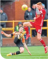  ??  ?? Alloa’s Iain Flannigan tackles Connor Malley