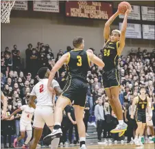  ?? Photo courtesy of JBU Sports Informatio­n ?? John Brown’s Ira Perrier goes high into the air for a rebound Friday against Barclay (Kan.) in the annual Toilet Paper Game at Bill George Arena.