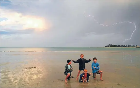  ?? Photo: NGARETA CAMPION ?? No fear: From left, Judah Grubham, 11 of Stoke, Ezra Campion, 10, Nikau Campion, 11 and, in front, Shael Campion, 6, of Tahunanui relish the storm.